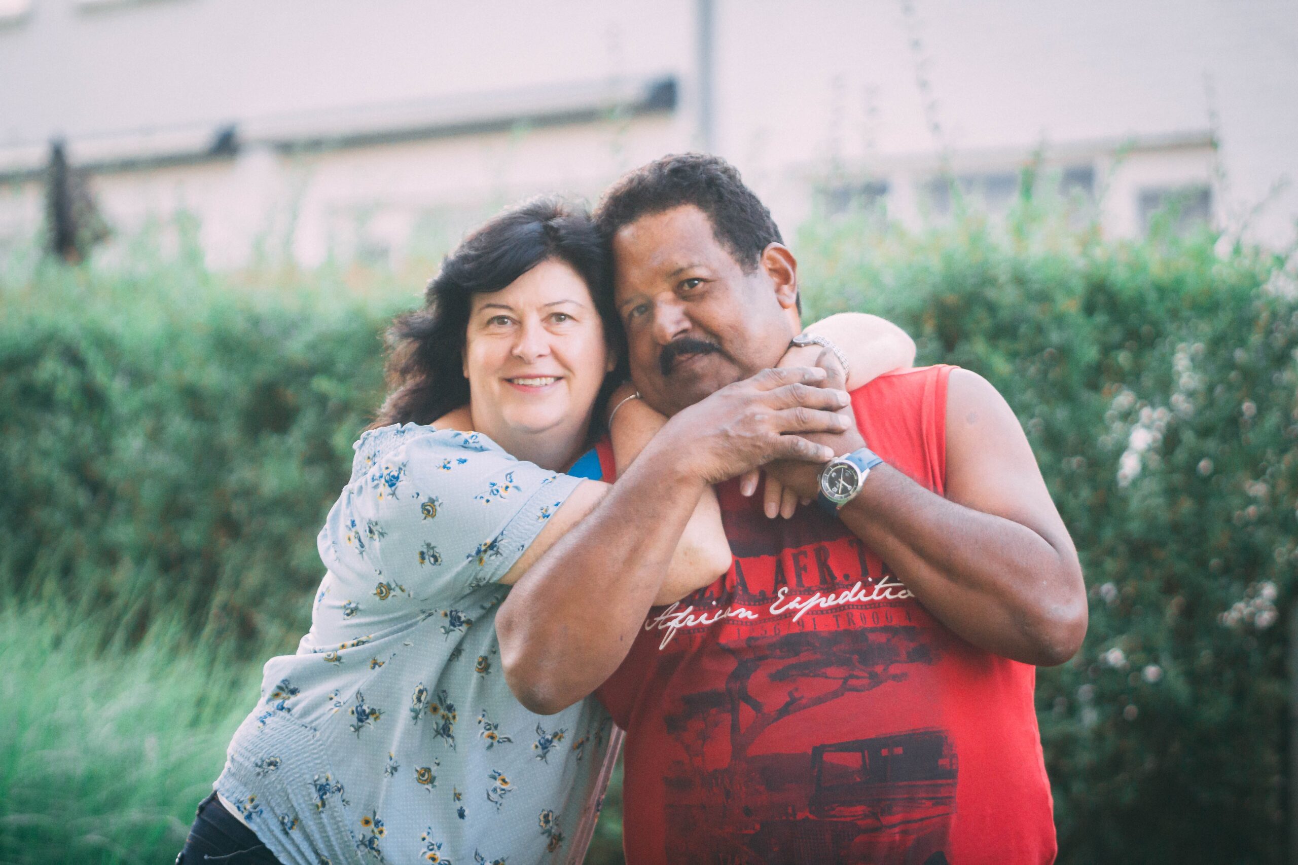 A loving multi-ethnic couple embracing each other with smiles on their faces. The focus of the image is on their embrace, which represents their affection and bond. The image depicts the beauty of multi-ethnic relationships and promotes the idea that love knows no boundaries. It is a perfect representation of the benefits of couples therapy in Connecticut, where individuals from diverse backgrounds can seek help to strengthen their relationships and overcome challenges.