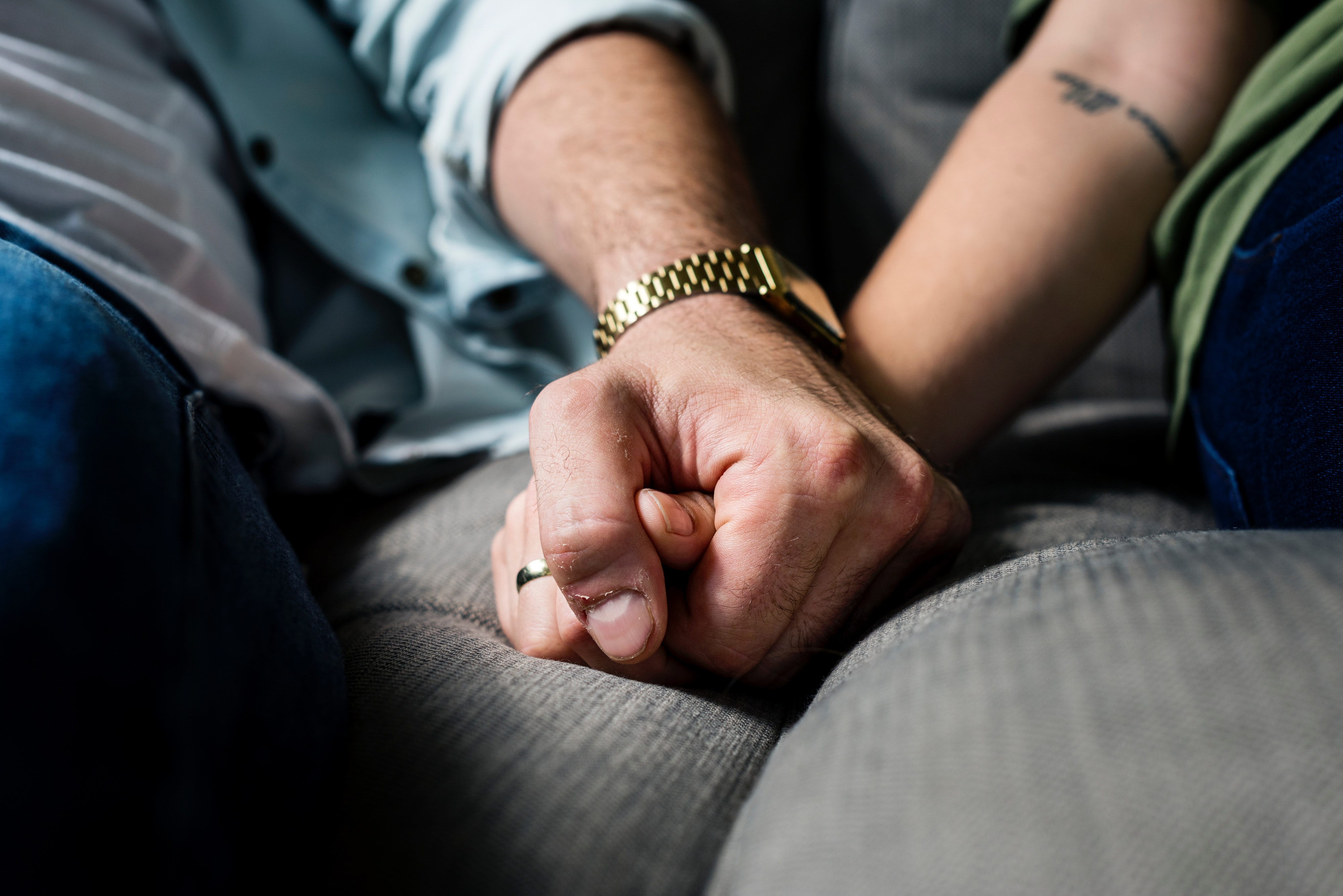 A couple holds hands in a counseling office. This image represents the connection that can result from couples therapy in Connecticut.
