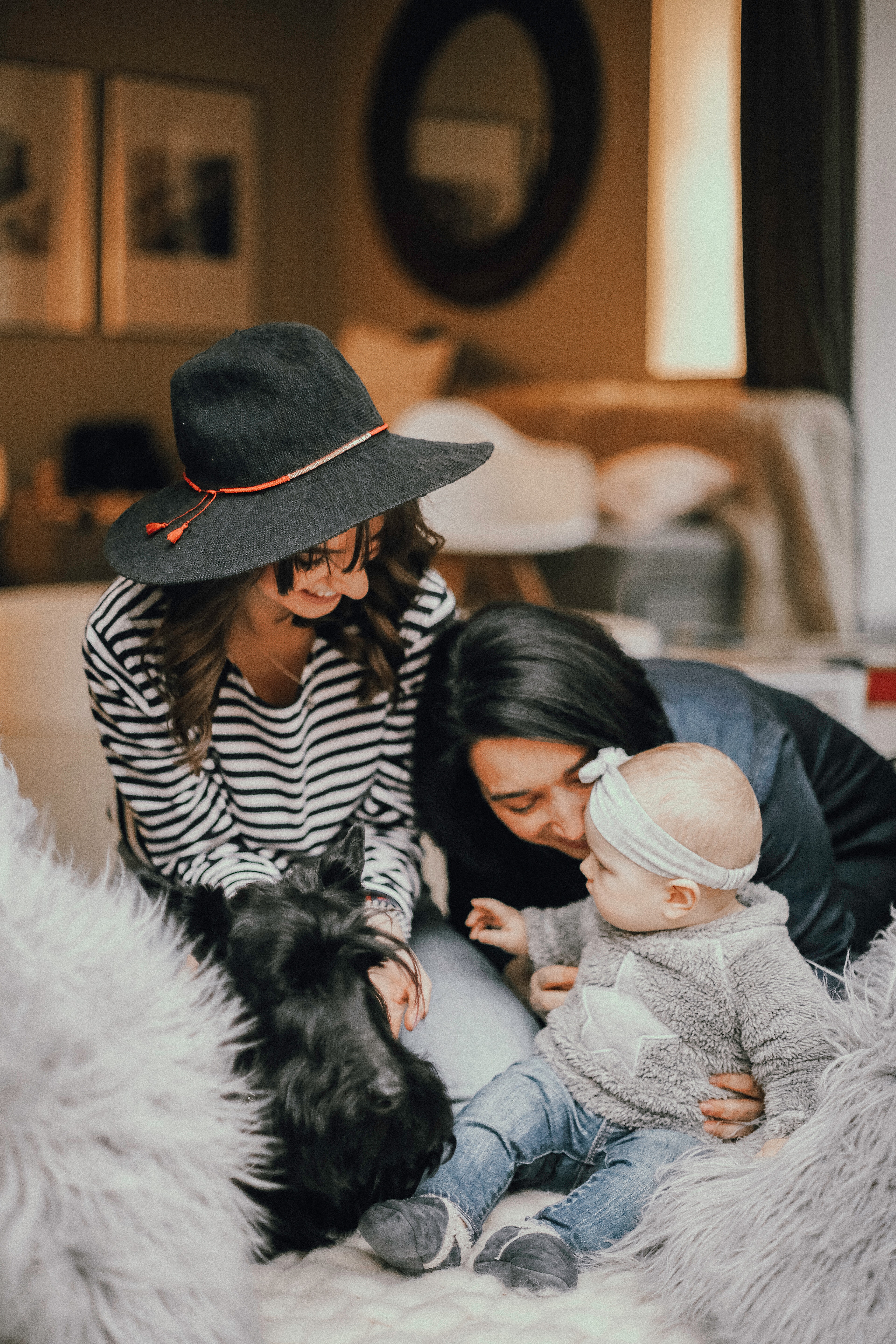 An image of a family of three, consisting of an adult, a baby, and a child, standing together and looking at each other with love and affection. The focus of the image is on their connection, representing the importance of family relationships. The image promotes the idea of seeking family therapy in Connecticut, where families can work together to improve communication and overcome challenges. The image evokes a sense of warmth and the idea that with support and guidance, families can build stronger and happier relationships.