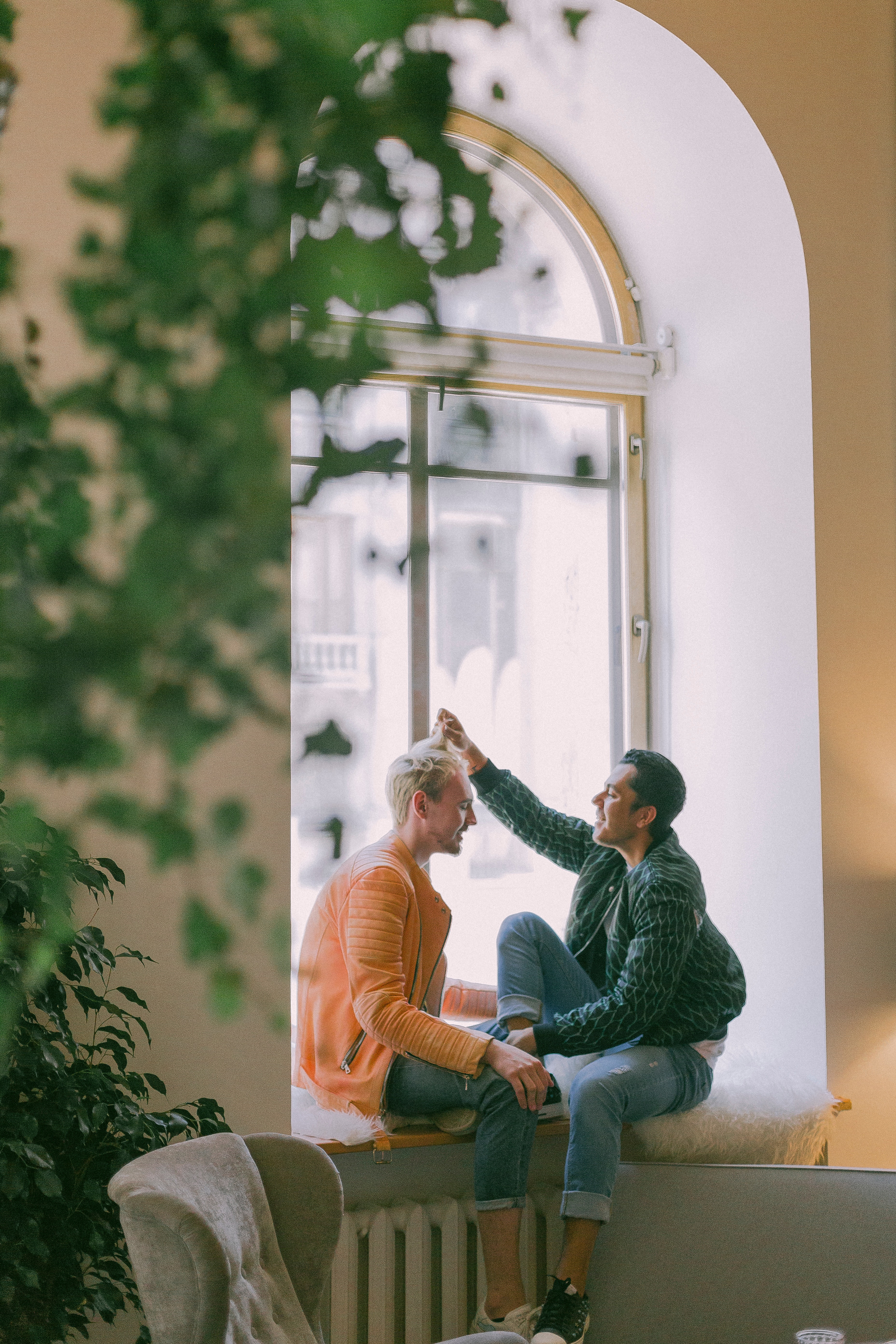 An image of two men, one is touching the other's hair and looking at the other with a sense of love and understanding. The image represents the importance of LGBTQ relationships and the need for support and guidance in navigating the challenges that can arise. The image promotes the idea of seeking LGBTQ therapy, where individuals and couples can find a safe and supportive environment to explore their emotions and work towards building healthier relationships. The image evokes a sense of intimacy, trust, and the importance of connecting with others who share similar experiences.